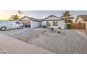 Charming single-story home featuring a xeriscaped front yard and white exterior at 2006 W Summit Pl, Chandler, AZ 85224