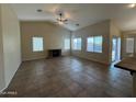 Spacious living room with tile flooring, a stone fireplace, and large windows at 2010 E Indigo Dr, Chandler, AZ 85286