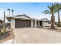 Inviting single-story home featuring a well-maintained yard with desert landscaping and a spacious two-car garage at 20210 N 124Th Dr, Sun City West, AZ 85375