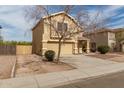 Inviting two-story house featuring a well-manicured lawn and a cozy front porch at 2558 W Jasper Ave, Apache Junction, AZ 85120