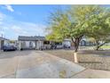 A well-maintained home features a convenient carport and attractive landscaping at 303 W Hazelwood St, Phoenix, AZ 85013