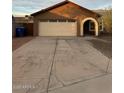 Home featuring a two car garage and desert landscaping at 304 E Madison St, Avondale, AZ 85323