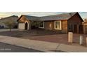 Single-story house featuring neutral stucco, a gray roof, and desert landscaping at 304 E Madison St, Avondale, AZ 85323