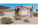 Charming single-story home featuring a two-car garage and low-maintenance desert landscaping at 320 W Phantom Dr, Casa Grande, AZ 85122