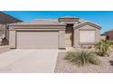 Charming single-story home featuring a two-car garage and low-maintenance desert landscaping at 320 W Phantom Dr, Casa Grande, AZ 85122