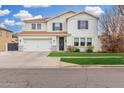 Traditional two-story home featuring a manicured lawn, a two-car garage and a welcoming entrance at 3760 E Cotton Ct, Gilbert, AZ 85234