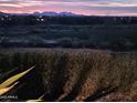 This beautiful view showing desert landscape with some mountains in the far background at 41225 N River Bend Rd, Phoenix, AZ 85086