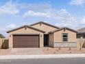 Charming single-story home featuring a two-car garage, neutral-toned stucco and a stone veneer accent at 4248 W Hannah St, San Tan Valley, AZ 85144