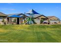 Community playground featuring a picnic pavilion, playground equipment, seating area, and well-maintained landscaping at 4248 W Hannah St, San Tan Valley, AZ 85144