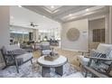 Bright living room featuring modern decor, hardwood floors, and an open floor plan to the kitchen at 44409 N 43Rd Dr, Phoenix, AZ 85087