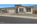 Beautiful home featuring stone accents, and a well maintained lawn at 44717 N 44Th Dr, Phoenix, AZ 85087