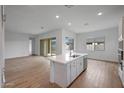 Open-concept kitchen and living area with wood floors and natural light at 44721 N 44Th Dr, Phoenix, AZ 85087