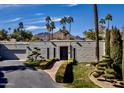 Contemporary home featuring manicured landscaping, mountain views and a private driveway at 5682 N Scottsdale Rd, Paradise Valley, AZ 85253