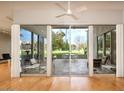 Expansive living room showcasing sliding glass doors that lead to an outdoor patio and manicured lawns at 5682 N Scottsdale Rd, Paradise Valley, AZ 85253