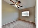 Bedroom with neutral walls, carpeted floor, window with blinds and a ceiling fan with lights at 625 S Westwood St # 108, Mesa, AZ 85210