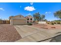 Single-Gathering home boasts a two-car garage, long driveway and a well-manicured front yard with mature trees at 6915 E Gary Cir, Mesa, AZ 85207