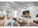 Cozy living room area featuring a modern fireplace and a large, comfortable white sofa at 7121 E Rancho Vista Dr # 5011, Scottsdale, AZ 85251