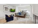 Inviting living room with a comfy sofa, accent chair, mounted TV, and light tile floors at 7126 N Via Nueva --, Scottsdale, AZ 85258