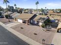 Aerial view of a single-story home with desert landscaping, a two-car garage, and a neutral-colored roof at 840 E Hackamore St, Mesa, AZ 85203