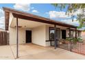 Well-maintained single-story home with covered parking and mature desert landscaping at 1004 S Ironwood Dr, Apache Junction, AZ 85120