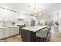 Stylish kitchen with stainless steel appliances, quartz countertops, and bar seating at the kitchen island at 10215 E Hillery Dr, Scottsdale, AZ 85255