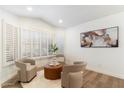 Bright sitting area with natural light, stylish chairs, and a decorative ottoman on a soft area rug at 10215 E Hillery Dr, Scottsdale, AZ 85255