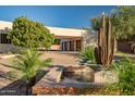 Long driveway leading to a home with a water feature, desert landscaping, and ample parking at 10301 N 128Th St, Scottsdale, AZ 85259