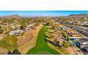 Aerial view of a residential community with a golf course, homes, and lush greenery at 1031 W Indian Hills Pl, Phoenix, AZ 85023