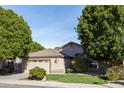 Single-story home with well-maintained lawn, desert landscaping, and attached two-car garage at 1054 W Park Ave, Gilbert, AZ 85233