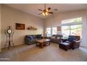 Spacious living room with vaulted ceiling, large windows, comfortable seating, and neutral carpet at 1054 W Park Ave, Gilbert, AZ 85233