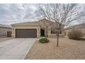 Single-story home with desert landscaping, a tile roof, and a two-car garage at 10705 E Sunflower Ct, Florence, AZ 85132