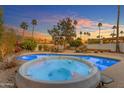 Backyard pool with a hot tub and desert landscaping at sunset at 11041 N 44Th St, Phoenix, AZ 85028