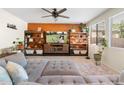 Comfortable living room with modern decor, a large sectional, and decorative shelving at 12038 W Briles Rd, Peoria, AZ 85383