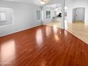 Bright open living room with hardwood floors, neutral paint, ceiling fan, and great natural light at 12163 W Chase Ln, Avondale, AZ 85323