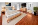 Cozy main bedroom featuring hardwood floors and modern decor for a comfortable retreat at 12163 W Chase Ln, Avondale, AZ 85323