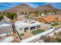 Aerial view of a desert home, highlighting the backyard putting green and desert landscape at 1219 E Seminole Dr, Phoenix, AZ 85022