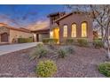 Charming Tuscan-style home featuring desert landscaping with stone accents and a well-maintained front yard at 13719 W Creosote Dr, Peoria, AZ 85383