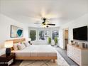 Cozy main bedroom features a large bed, a ceiling fan, and multiple windows for natural light at 1405 E Cathedral Rock Dr, Phoenix, AZ 85048