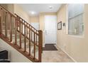 Bright foyer with staircase and tiled flooring at 1458 N 80Th Ln, Phoenix, AZ 85043