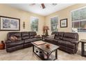 Cozy living room featuring tile floors, ceiling fan and two windows at 1458 N 80Th Ln, Phoenix, AZ 85043