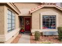 Close-up of the home's entrance, highlighting the red front door and well-maintained landscaping at 1514 E Hearne Way, Gilbert, AZ 85234