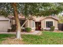 Charming single-story home with desert landscaping, a red front door, and a tile roof at 1514 E Hearne Way, Gilbert, AZ 85234