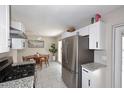 Bright kitchen featuring stainless steel appliances, white cabinets, and granite countertops at 1515 E Sunnyslope Ln, Phoenix, AZ 85020