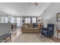 Inviting living area flows into dining space, featuring an open layout and neutral color palette at 1706 E Lindrick Dr, Chandler, AZ 85249