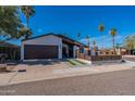 Beautiful single-story home showcasing modern design and desert landscaping, complete with an attached garage at 1830 N 87Th Ter, Scottsdale, AZ 85257