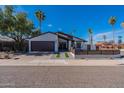 Inviting single-story home boasting a modern fence, desert landscaping, and a convenient attached two-car garage at 1830 N 87Th Ter, Scottsdale, AZ 85257