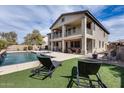 Lush backyard featuring a large pool, covered patio, and plenty of room for outdoor entertaining at 22050 N Balboa Dr, Maricopa, AZ 85138