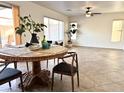 Bright dining area featuring a round wood table, neutral paint, and views of the backyard at 2344 W Barwick Dr, Phoenix, AZ 85085