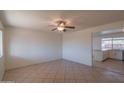 Bright living room featuring tile floors, a ceiling fan, and a view into the updated kitchen at 2507 E Golden St, Mesa, AZ 85213