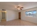 Inviting living room with tile floors, a ceiling fan, and a sunlit window with neighborhood views at 2507 E Golden St, Mesa, AZ 85213